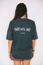 Load image into Gallery viewer, Female model showing the back of the grey conscious collection t-shirt