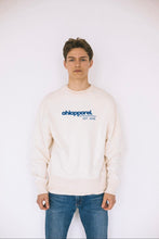 Load image into Gallery viewer, Model wearing AHL Apparel Natural Raw unisex sweatshirt with blue logo