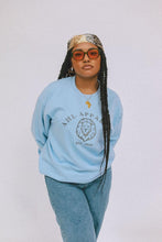 Load image into Gallery viewer, Model wearing AHL Apparel Serene Blue sweatshirt with lion graphic