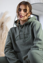 Load image into Gallery viewer, Female hunched down modelling khaki tracksuit
