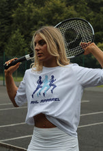 Load image into Gallery viewer, Female modelling white Sport Luxe t-shirt with tennis racket behind her head
