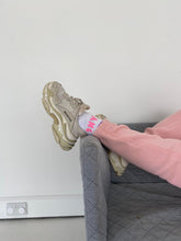 Load image into Gallery viewer, Modelling lying on sofa showing white and pink AHL socks
