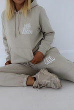 Load image into Gallery viewer, Female sitting on floor modelling she just shines cream tracksuit
