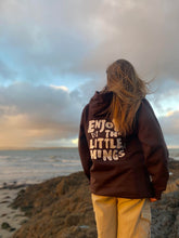 Load image into Gallery viewer, Female modelling brown enjoy the little things hoodie on a beach
