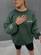 Load image into Gallery viewer, Female modelling green MWC sweatshirt
