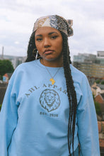 Load image into Gallery viewer, AHL Apparel Serene Blue unisex sweatshirt with lion graphic on model
