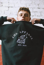 Load image into Gallery viewer, Male model wearing AHL Wolf black oversized graphic sweatshirt
