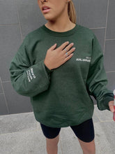 Load image into Gallery viewer, Model wearing grey AHL Apparel sweatshirt with Made With Care sleeve print
