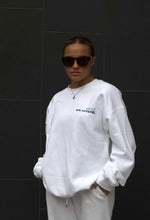 Load image into Gallery viewer, Model wearing white AHL Apparel sweatshirt with Made With Care sleeve print
