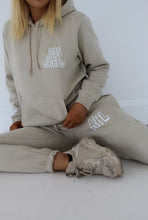 Load image into Gallery viewer, Female sitting on floor wearing she just shines cream tracksuit
