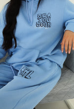 Load image into Gallery viewer, Female sitting on sofa wearing blue sea you soon tracksuit
