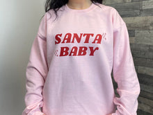 Load image into Gallery viewer, Female wearing pink Santa Baby sweatshirt
