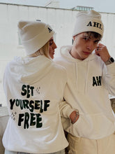 Load image into Gallery viewer, Male and female model wearing set yourself free hoodie and beanie in white
